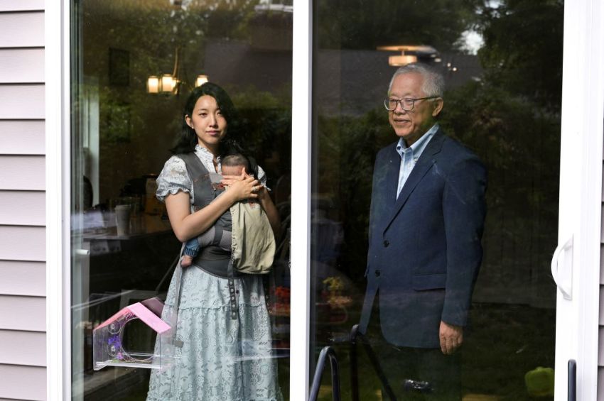 Chinese founder of Zion Church Ezra Jin (right) and his daughter, Grace Jin Drexel (left), pose for a photo in Cheverly, Maryland on Aug. 11, 2026. Grace Jin Drexel is holding her infant son, baby Ezra.