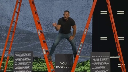 Pastor Josh Howerton of Lakepointe Church in Rockwall, Texas, uses two large ladders to illustrate the difficulty of a Christian trying to please the world during a sermon on Sept. 20, 2026.