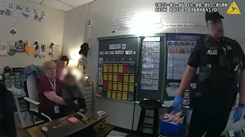 A teacher at Richneck Elementary School in Newport News, Virginia, is shown in this still from body camera video restraining a 6-year-old first grader (identity protected) who is cursing at everyone after he shot his teacher, Abigail Zwerner, on Jan. 6, 2023.
