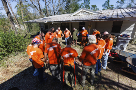 Volunteers with Samaritan's Purse pray together during relief efforts after Hurricane Isaias.