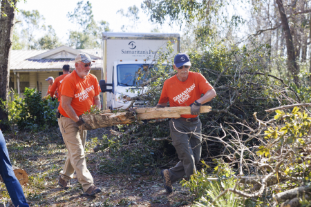 Volunteers with Samaritan's Purse remove downed trees after Hurricane Isaias.