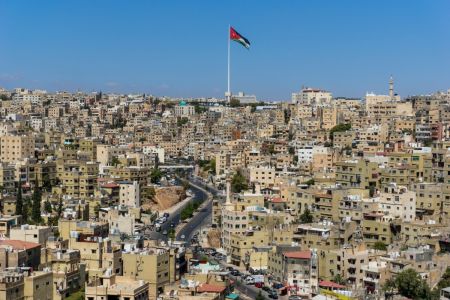 A flag flies on a clear day in Amman, Jordan.