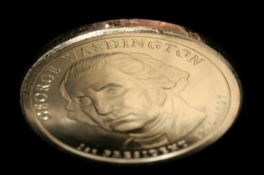 In this undated photo released by Professional Coin Grading Service, a George Washington dollar coin missing the edge inscription is shown. An unknown number of new George Washington dollar coins were struck without their edge inscriptions, including 'In God We Trust,' and made it past inspectors and into circulation, the U.S. Mint said Wednesday, March 7, 2007.