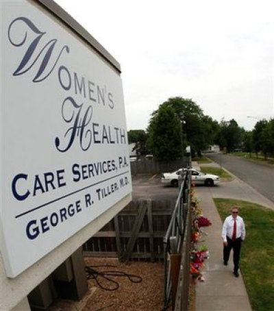 John Pride of Wichita, Kansas, walks past a memorial outside Women's Health Care Services. The family of slain abortion provider George Tiller said Tuesday, June 9, 2009, that Tiller's Wichita clinic will be 