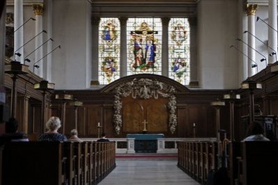 People pray inside St James's Church at Piccadilly in central London, Thursday, July 23, 2009. The Church of England is offering couples a two-for-one service, marriage for them and baptisms for their children. The church says it is recognizing the changing reality of British families and statistics show that 44 percent of children in Britain are born to unmarried women.
