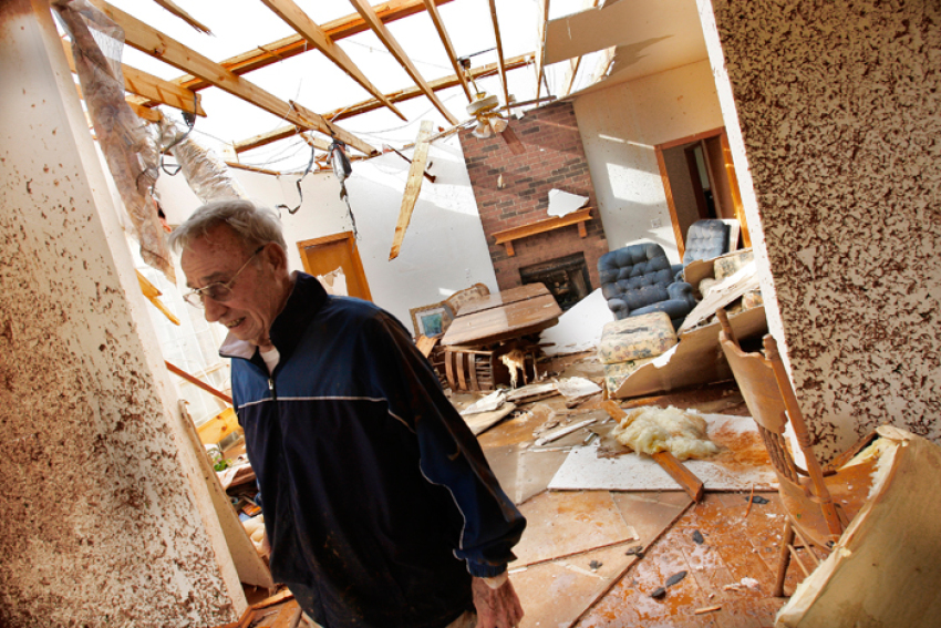 Ken Haebaum stands in his mud-splattered kitchen after a tornado ripped through the Falcon Lake area of Piedmont, Oklahoma May 24, 2011. Haebaum and his wife sought shelter from the tornado in the hallway behind the door on the right side of the photo. Several tornadoes touched down in Oklahoma on Tuesday afternoon, the largest one striking El Reno, west of Oklahoma City, and continuing to the northeast, the National Weather Service said. The living room is seen in the background.