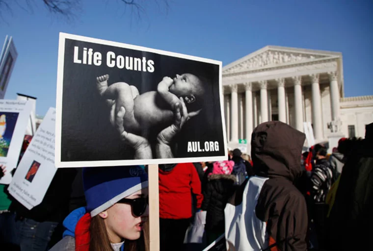 Pro-life protesters file past the U.S. Supreme Court Building during the annual March for Life in Washington January 24, 2011. | Reuters /Jason Reed)