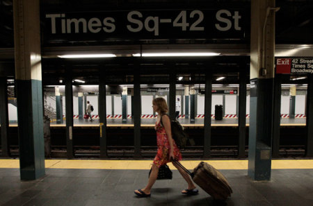 A woman walks through the Times Square subway station after the last subway has left, August 27, 2011. Mayor Michael Bloomberg sternly warned New Yorkers to follow the city's unprecedented mandatory evacuation orders on Saturday, saying approaching Hurricane Irene is