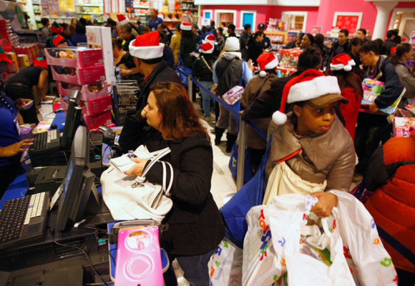 Customers shop at Toys "R" Us in New York November 24, 2011. Stores looking to grab as big a piece as possible of what is expected to be a middling holiday shopping season pushed post-Thanksgiving openings into Thursday evening, getting an early start on "Black Friday," the traditional start to the U.S. holiday shopping season.