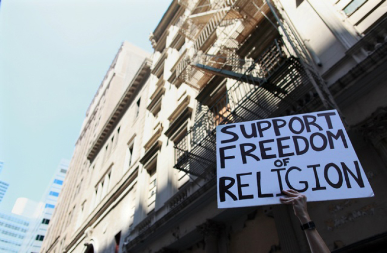 Protester in Manhattan, New York Holds Sign Supporting Religious Freedom