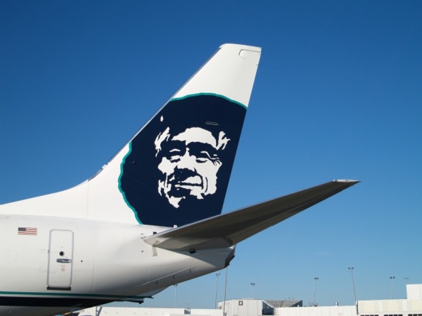 This photo shows the tail end of one of Alaska Airlines' jets, which feature the image of a smiling Eskimo man.