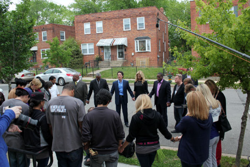 Joel and Victoria Osteen join in a circle of prayer outside of the 