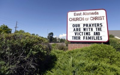 A sign in memory of the victims killed by a gunman that opened fire in a movie theater is seen at the East Alameda Church of Christ in Aurora, Colorado, July 22, 2012. President Barack Obama will travel to Colorado on Sunday to meet with the families of victims of a shooting rampage at a packed midnight showing of the new "Batman" film in the Denver suburb of Aurora that killed at least 12 people and wounded 58.
