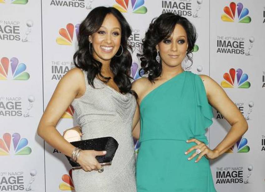 "Sister, Sister" actresses Tamera Mowry-Housley and her sister Tia Mowry arrive at the 43rd NAACP Image Awards in Los Angeles