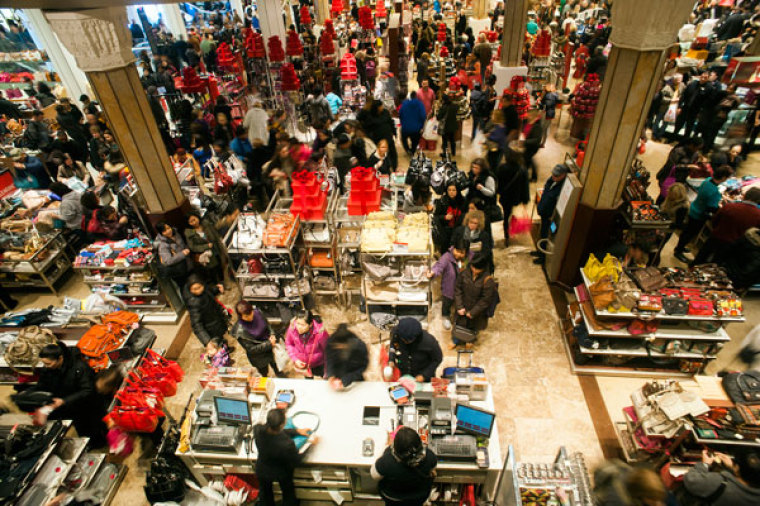 Shoppers look over items on sale at a Macy's store in New York, November 23, 2012. Black Friday, the day following the Thanksgiving Day holiday, has traditionally been the busiest shopping day in the United States.