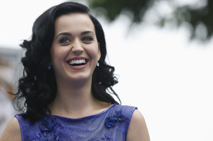 Singer Katy Perry smiles at the premiere of "The Smurfs 2" at the Regency Village theatre in Los Angeles.
