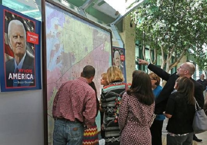 Organizers for the "My Hope America with Billy Graham" project at Prestonwood Baptist Church posted giant maps of the surrounding area, using red dots to indicate a host home, [FILE]
