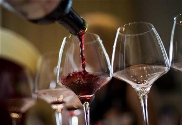 Waiter pouring glass of wine