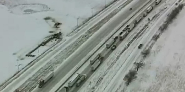 Eighteen-wheelers and cars pile up along Interstate 35 after an ice storm in Texas
