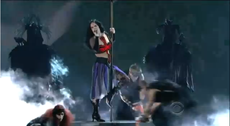Katy Perry uses an upside-down witch's broom as a pole to pole dance in her