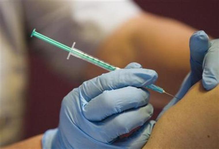 A medical assistant injects a vaccine in a file photo. | Reuters/Michael Buholzer