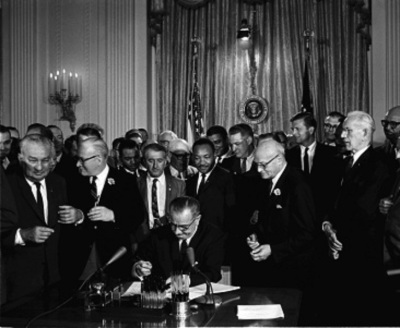 President Lyndon Baines Johnson signing the Civil Rights Act into law on July 2, 1964.