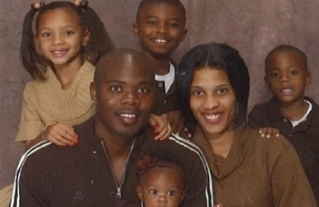 Cornealious Michael Anderson III poses for a photo with his family.