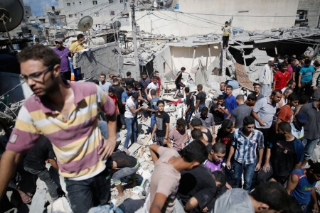 Palestinians dig through the rubble of a building searching for bodies after what police said was an Israeli air strike at Shati (Beach) refugee camp in Gaza City August 4, 2014. A seven-hour truce under which Israel would unilaterally hold fire in most of the Gaza Strip went into force on Monday and Palestinians immediately accused Israel of breaking the ceasefire by bombing a house in Gaza City. Gaza officials say 1,796 Palestinians, most of them civilians, have been killed and more than a quarter of the impoverished enclave's 1.8 million residents displaced. As many as 3,000 Palestinian homes have been destroyed or damaged. Israel has lost 64 soldiers in combat and three civilians to Palestinian cross-border shelling that has emptied many of its southern villages.