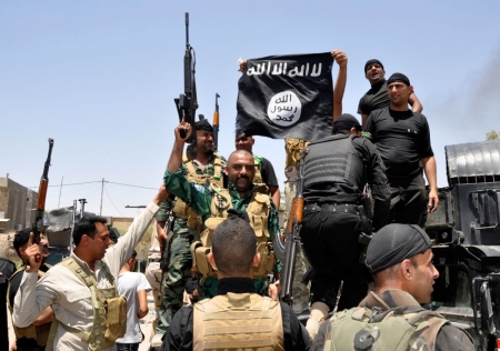 Iraqi security forces pull down a flag belonging to Sunni militant group Islamic State of Iraq and the Levant (ISIL) during a patrol in the town of Dalli Abbas in Diyala province, June 30, 2014. The leader of the al Qaeda offshoot now calling itself the Islamic State has called on Muslims worldwide to take up arms and flock to the "caliphate" it has declared on captured Syrian and Iraqi soil. Picture taken June 30, 2014.