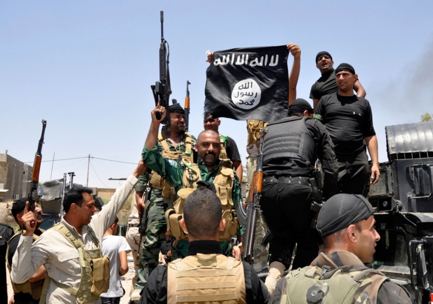 Iraqi security forces pull down a flag belonging to Sunni militant group Islamic State of Iraq and the Levant (ISIL) during a patrol in the town of Dalli Abbas in Diyala province, June 30, 2014. The leader of the al Qaeda offshoot now calling itself the Islamic State has called on Muslims worldwide to take up arms and flock to the "caliphate" it has declared on captured Syrian and Iraqi soil. Picture taken June 30, 2014.