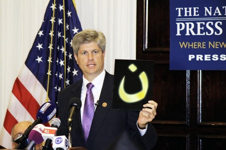 Speaking at the In Defense of Christians Press Conference at the National Press Club in Washington, D.C., U.S. Rep. Jeff Fortenberry holds up the Arabic letter "N" pronounced "noon" which stands for the word Nazarenes, which is used as a Arabic derogatory term for Christians. Islamic State forces have been spray painting the letter in "blood red" marking the homes or businesses of Christians in Mosul, Iraq.