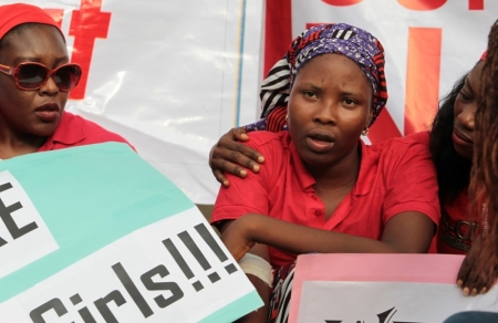 saac Rebecca, one of the girls that escaped from the Boko Haram camp, is comforted during a protest march, in continuation of the Global Week of Action to commemorate six months since the abduction of the 219 Chibok school girls, organized by the Abuja "Bring Back Our Girls" protest group to the Presidential Villa, in Abuja, Nigeria, October 14, 2014.
