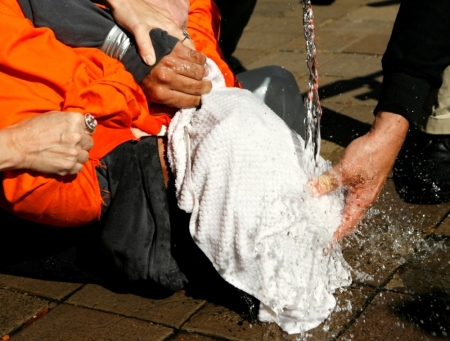 Demonstrator Maboud Ebrahimzadeh is held down during a simulation of waterboarding outside the Justice Department in Washington, November 5, 2007.