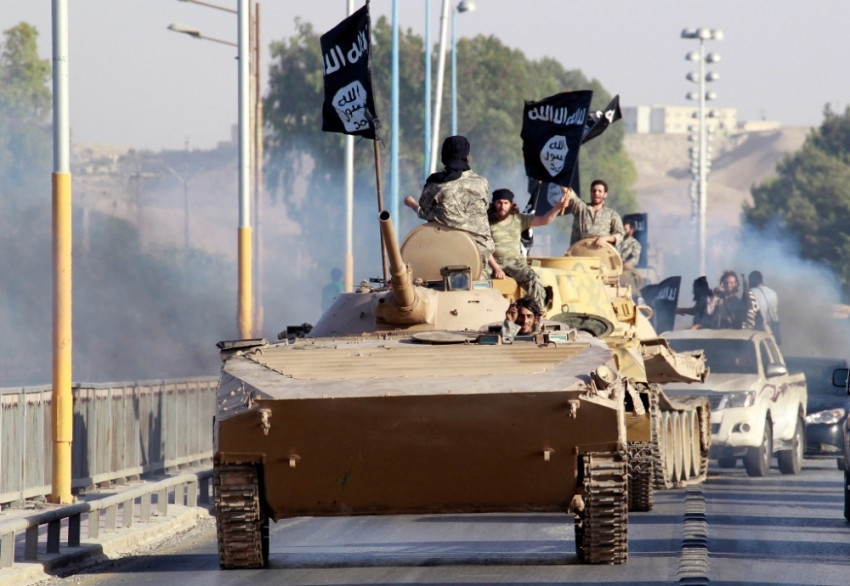 Militant Islamist fighters take part in a military parade along the streets of the northern Raqqa province, June 30, 2014. Militant Islamist fighters held a parade in Syria's northern Raqqa province to celebrate their declaration of an Islamic