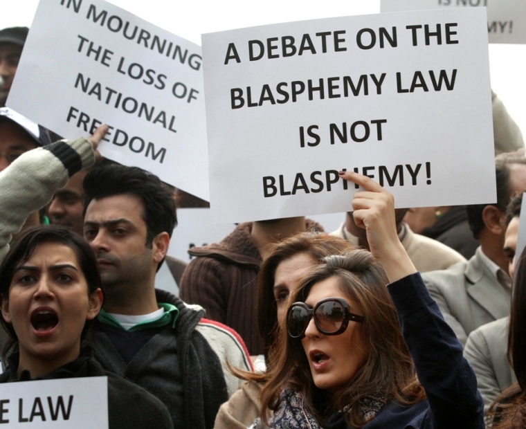 A woman holds a placard during a rally protesting the killing of the Punjab Gov. Salman Taseer in Lahore, Pakistan, on January 8, 2011. Taseer was shot dead by one of his guards, who was apparently incensed by the politician's opposition to the blasphemy law in Islamabad on January 4, 2011. | Reuters/Mohsin Raza