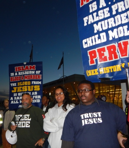 Ruben Israel (L), a member of Bible Believers, is joined by hundreds of protesters at a rally outside the