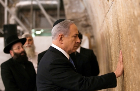 Israel's Prime Minister Benjamin Netanyahu touches the stones of the Western Wall, Judaism's holiest prayer site, in Jerusalem's Old City, March 18, 2015.
