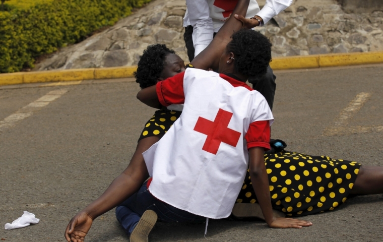 A relative falls while she is assisted by Kenya Red Cross staff where bodies of the students killed in Thursday's attack by gunmen, are preserved at the Chiromo Mortuary in the capital Nairobi, April 4, 2015. Somali militants vowed on Saturday to wage a long war against Kenya and run its cities
