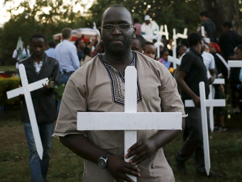 People carry wooden crosses, symbolizing the people killed by gunmen at the Garissa University College, as they arrive for a memorial vigil at the