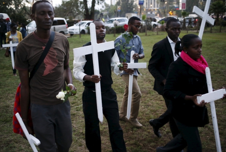 People carry wooden crosses, symbolizing the people killed by gunmen at the Garissa University College, during a memorial vigil at the