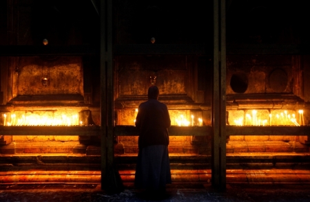 A nun prays by the tomb of Jesus in the Church of Holy Sepulchre in Jerusalem's Old City, November 27, 2009.