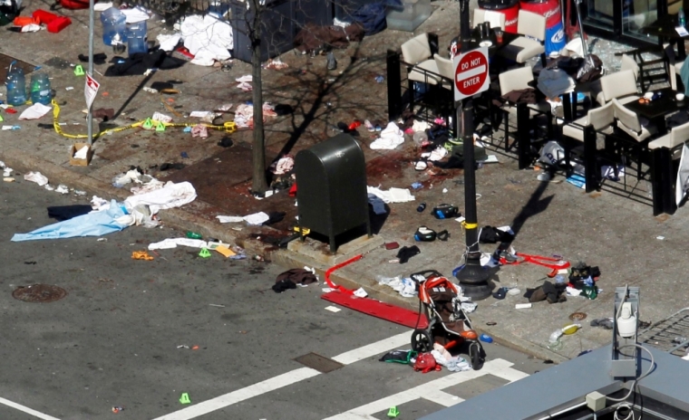 Blood and debris are seen on the sidewalk along Boylston Street a day after two explosions hit the Boston Marathon in Boston, Massachusetts, April 16, 2013. Two bombs packed with ball bearings tore through crowds near the finish line of the Boston Marathon on Monday, killing three people and triggering a massive hunt for those behind an attack the White House said would be treated as "an act of terror."