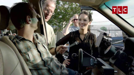 Christian motivational speaker Nick Vujicic sits behind the wheel of a customized car in the TLC special "Man Born Without Limbs."