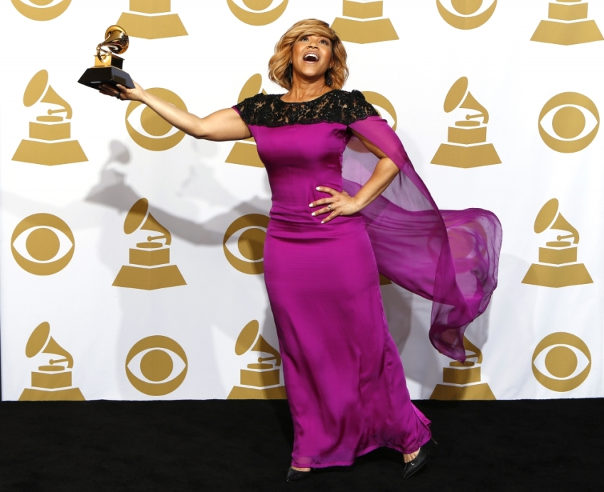 Erica Campbell holds the award for Best Gospel Album for "Help" backstage during the awards pre-telecast at the 57th annual Grammy Awards in Los Angeles, California, February 8, 2015.