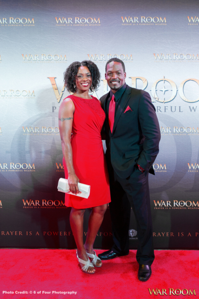 Actor T.C. Stallings poses with his wife for photographers at the Atlanta red carpet premiere of "War Room" in Atlanta, Georgia, on August 20, 2015.