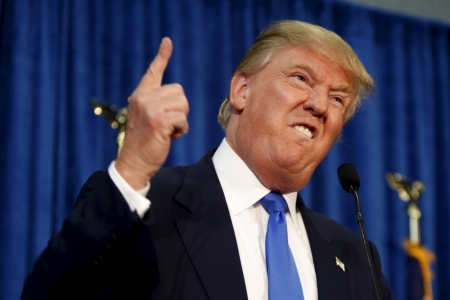 Republican presidential candidate Donald Trump gestures and declares