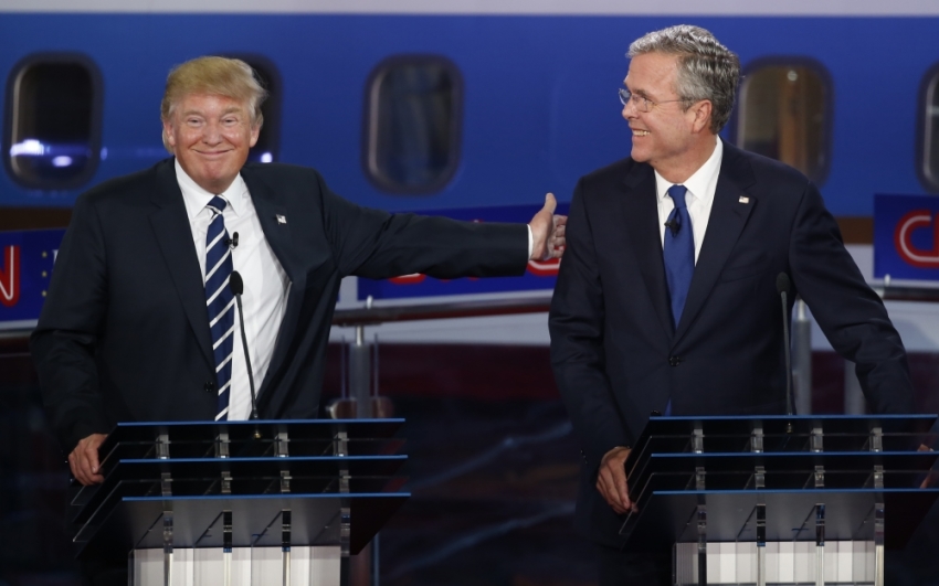 Republican U.S. presidential candidate and businessman Donald Trump (L) reaches out to pat former Florida Governor Jeb Bush on the back after Bush said he would want his Secret Service code name to be "Energizer" during the second official Republican presidential candidates debate of the 2016 U.S. presidential campaign at the Ronald Reagan Presidential Library in Simi Valley, California, United States, September 16, 2015.
