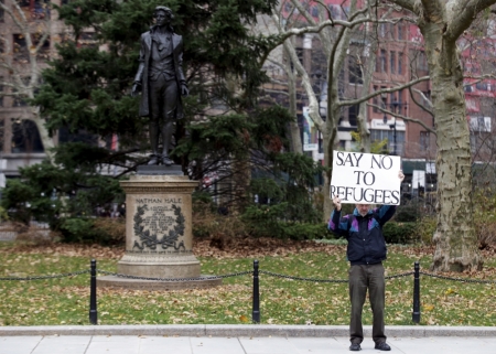 A supporter of U.S. Republican presidential candidate Donald Trump stands nearby during an interfaith rally at New York's City Hall in Manhattan December 9, 2015. Republican presidential front-runner Donald Trump's proposal to ban Muslims from entering the United States drew a growing wave of international criticism on Wednesday and cost him business in the Middle East.