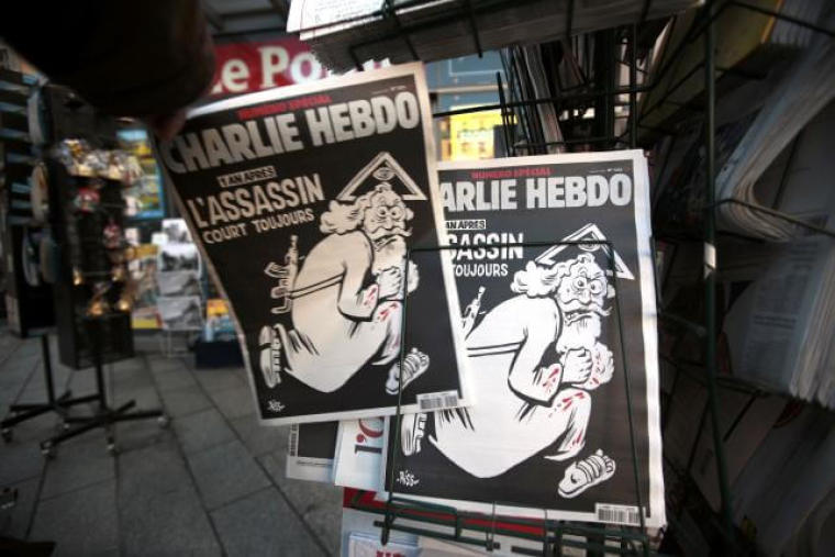 A man takes a copy of the latest edition of French weekly newspaper Charlie Hebdo with the title 'One year on, The assassin still on the run' displayed at a kiosk in Nice, France, January 6, 2016. | (Photo: Reuters/Eric Gaillard)