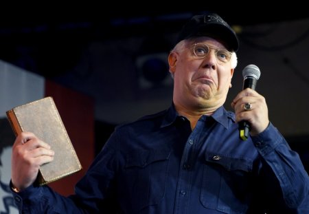Radio personality Glenn Beck, holds George Washington's copy of 